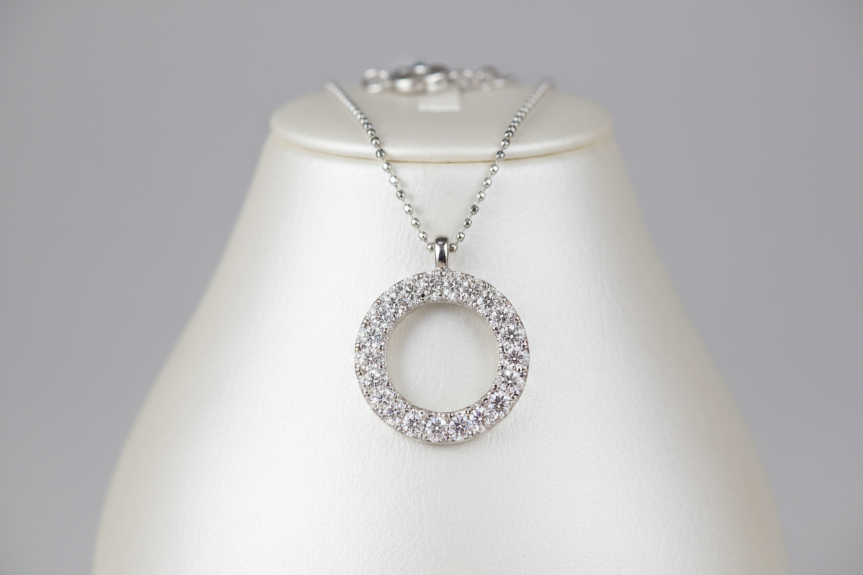 A mid-luxury diamond necklace featuring a circular motif encrusted with pavé diamonds, blending symbolic form (circle = eternity) with sparkle. Great entry-level luxury statement piece.
